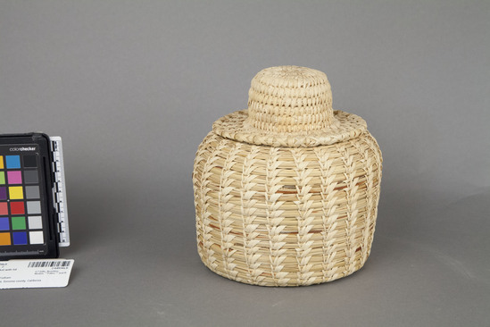 Hearst Museum object 2 of 2 titled Basket with lid, accession number 2-64934a,b, described as Squat jar shape with flat bottom, hat shaped lid.  Split stitch made of beargrass, sewn with yucca.  (a) Basket.  (b) Lid.