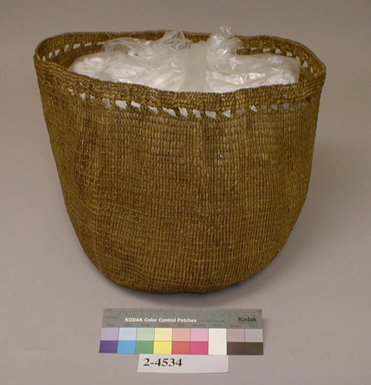 Hearst Museum object titled Bag, accession number 2-4534, described as Bag of woven grass, along mouth strands of warp are brought together in little braids about 1 cm in length, spaced at intervals of 1.5 cm.  Made with grass in open twining (rye grass leaves).