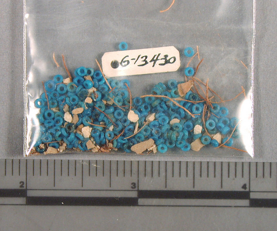 Hearst Museum object 1 of 3 titled Beads, accession number 6-13430, described as Beads: very small blue discs (rings) on original string; mass of small blue discs, piece count: 100+.