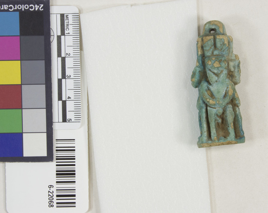 Hearst Museum object 9 of 11 titled Amulet (gods), accession number 6-22068, described as Four-sided amulet of blue faience, showing faience, showing Horus (two sides), Harpocrates, and Serket; length 56 mm.