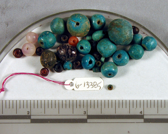 Hearst Museum object titled Beads, accession number 6-13385, described as Blue glaze and carnelian beads. [inv.: ball beads, piece count: 20+]