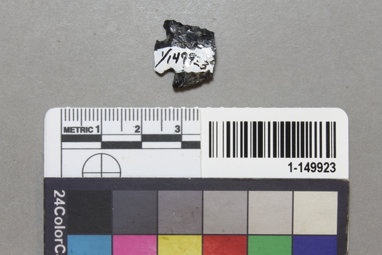 Hearst Museum object titled Projectile point fragment, accession number 1-149923, described as Obsidian. Expanding stem, corner notched, flat base. Fragment.