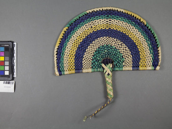 Hearst Museum object titled Woven fan, accession number 10-2334, described as Colored basketry fan; twined; semi-circle; yellow and purple handloop; 13 inches wide