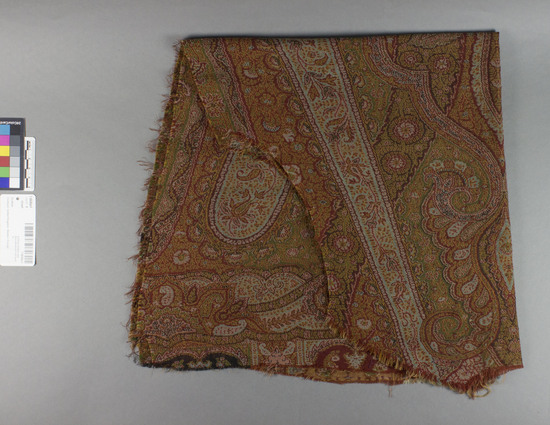 Hearst Museum object 5 of 6 titled Shawl, accession number 7-6640a-f, described as Five remnants fo Paisley shawl.  Wool.  Twill weave, brocaded.  Varicolored.  Floral, pine cone motives.  Condit. good.  A.  29 inches by 30 inches, very irregular.  B.  16¼ inches by 29½ inches, irregular.  C.  3¼ inches by 21 inches, irregular.