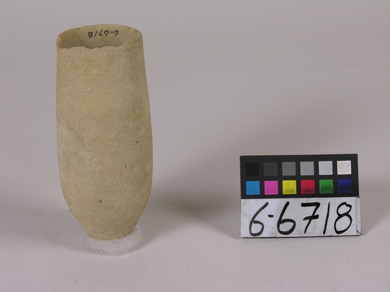 Hearst Museum object titled Beer cup, accession number 6-6718, described as Pottery: deep pointed-bottomed buff cup, rim chipped; least diameter 5 cm, greatest diameter 6 cm, height 15 cm.