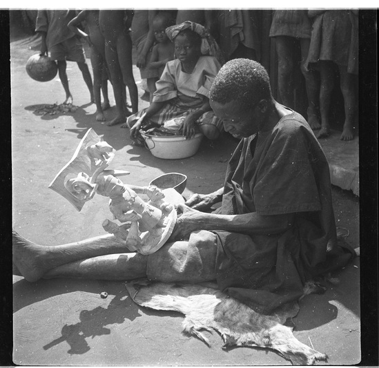 Hearst Museum object titled Black-and-white negative, accession number 15-30912, described as Black and white negative, 2.25'' Nigeria, Meko, Duga carving the Oshe Shango, Plate VII, 1951