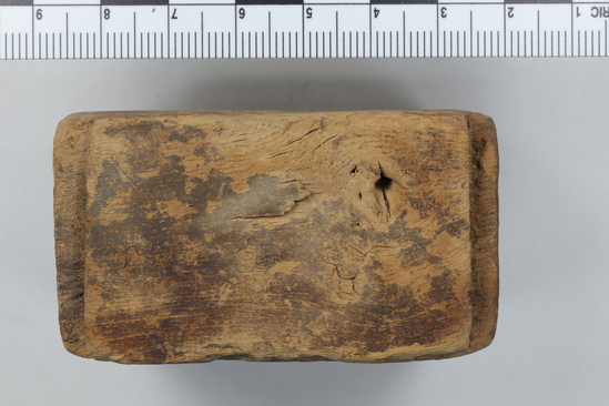 Hearst Museum object titled Wood block, accession number 6-13414, described as Block of wood, partly perforated (central hole on top), 5x6 cm.