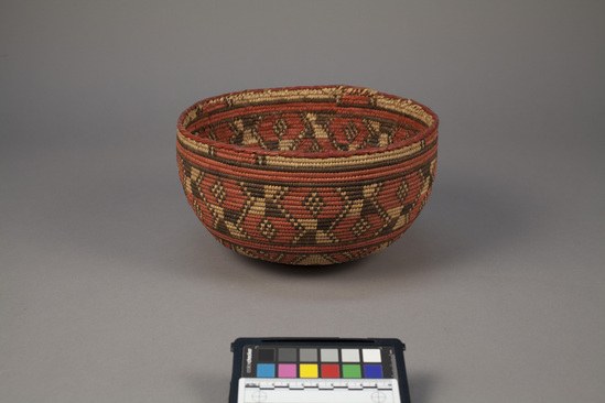 Hearst Museum object 2 of 2 titled Basket, accession number 5-2039, described as Hemispherical basket; coiled; red and black designs; leather sewing on rim and on base. Probably Nubian.