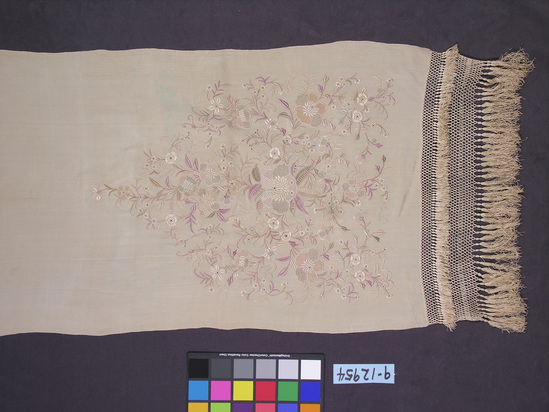 Hearst Museum object titled Shawl, accession number 9-12954, described as Shawl; Priest’s natural colored crepe with floral embroidery in pastel shades, deep fringe; materials/techniques: silk, embroidered.