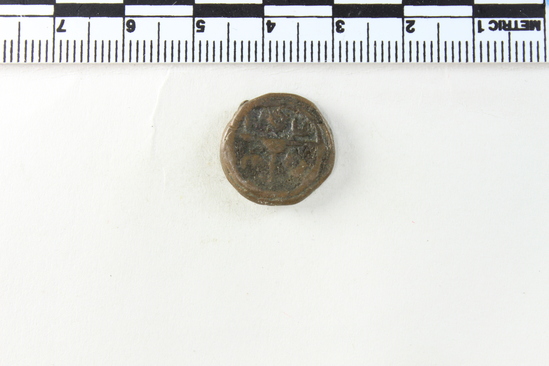 Hearst Museum object 2 of 6 titled Coin: æ 10 nummia (decanummium), accession number 6-23133, described as Obverse description: two frontal figures, soldiers perhaps, separated by a cross.. Reverse description: an I surmounted by a cross potent Left A; Right W. In exergue below AAN. Diameter 1.6 cm, weight 4.23 grams. Condition: fair.