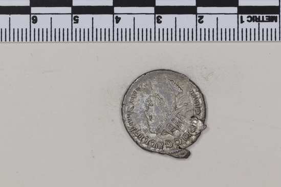 Hearst Museum object 7 of 8 titled Coin: billon antoninianus, accession number 8-4376, described as Coin; Billon; Antoninianus; Roman. 3.15 grams, 23 mm. Gallienus, 253-254 AD. Obverse: IMP C P LIC GALLIEVS AVG, bust r. radiate. Reverse: VIRTVS AVGG, soldier standing l.