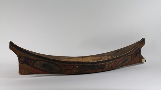 Hearst Museum object 3 of 6 titled Canoe model, accession number 2-10869, described as Model of canoe, painted totemic design in red, green, and black.  Wolf design (fide Charles Brown).