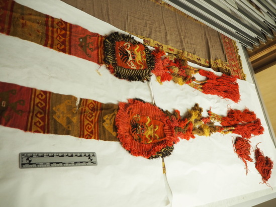 Hearst Museum object titled Textile, accession number 16-14945, described as Textile: long narrow band; polychrome-fancy-with medallions at each end, terminating in tassled fringes