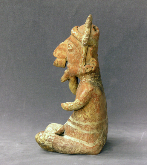 Hearst Museum object 2 of 3 titled Figurine, accession number 3-3608, described as Red pottery effigy of seated man with gourd rattle