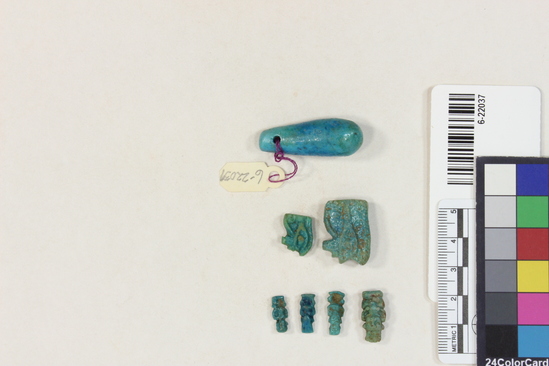 Hearst Museum object 3 of 22 titled Amulets, accession number 6-22037, described as amulets, of blue faience, and one pyramidal seal of steatite