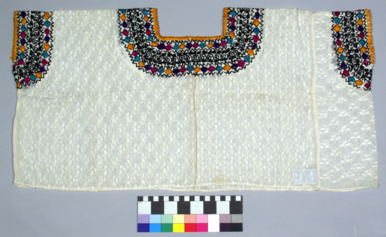 Hearst Museum object titled Huipil, accession number 3-28126, described as [ cat card DESCRIPTION: Blouse Materials: Cotton, silk Technique: Plain weave, embroidered Colors: White ground varicolored designs Dimensions: 14 x 28" Remarks:  Bead, wave motives. Factory woven. See Fig. 98a Textiles of Highland Guatemala, LMO    ]