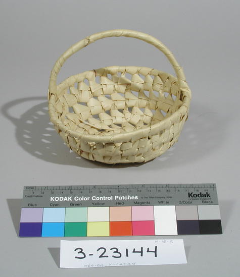 Hearst Museum object titled Basket, accession number 3-23144, described as Basket; loop stitched openwork coiling technique; made entirely of palm leaves including foundation and handle wrapping; arched handle; rim 17 cm by 20 cm; height 8 cm