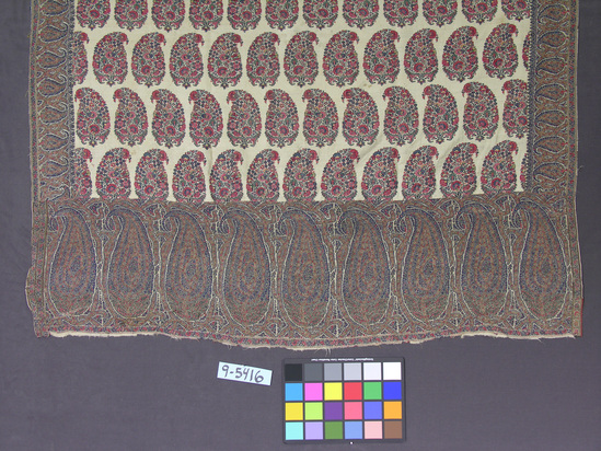 Hearst Museum object titled Shawl, accession number 9-5416, described as Kashmir shawl; white ground, varicolored floral pine cone designs in row and border. Ground has two seams. Repaired, patched border sections. 137 cm x 345.5 cm.