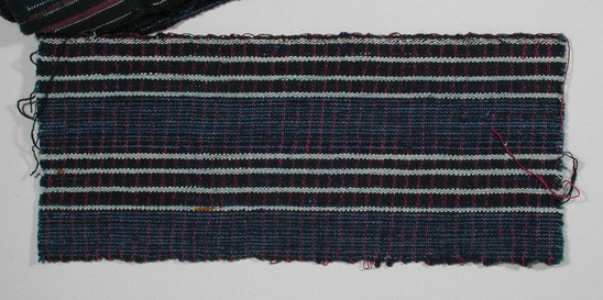 Hearst Museum object titled Textile fragment, accession number 5-11103, described as Textile sample (section of narrow band weaving): Navy ground; two sections white stripes alternating with two sections pale blue lines; magenta lines through weft; loops on left selvage.