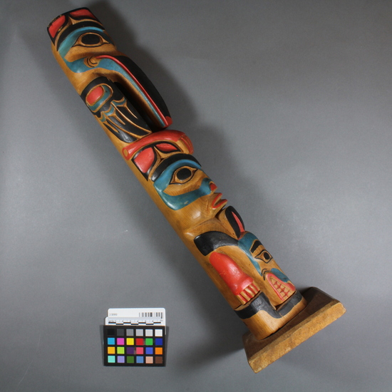 Hearst Museum object 4 of 4 titled Totem pole model, accession number 2-30950, described as Totem pole model. Painted red, blue, black; top to bottom: mosquito, probably a supernatural bear (Hootz), otter.  Deals with origin myth of Mosquito clan--see acc. envelope.