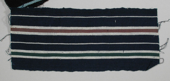 Hearst Museum object titled Textile fragment, accession number 5-11113, described as Textile sample (section of narrow band weaving): Deep blue ground with two narrow white stripes; one green and one maroon stripe ea. side flanked by equal white stripes.