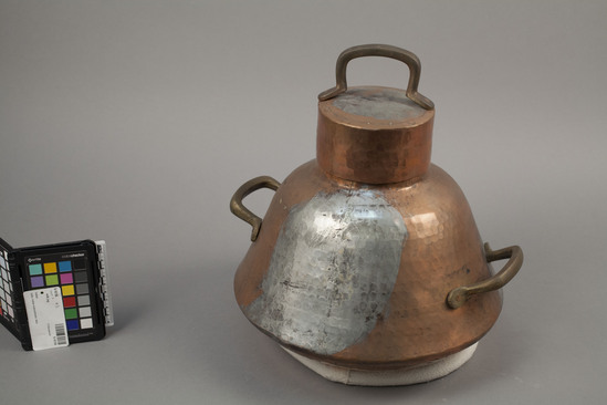 Hearst Museum object titled Milk jug, accession number 9-16156, described as Milk jug of hammered copper; two brass handles, and cover also has a brass handle. Jug (a) Circumference: 90cm, Cover(b) Height:5.5cm, Diameter: 12cm. Height of jug with cover: 35cm. Cost: $86