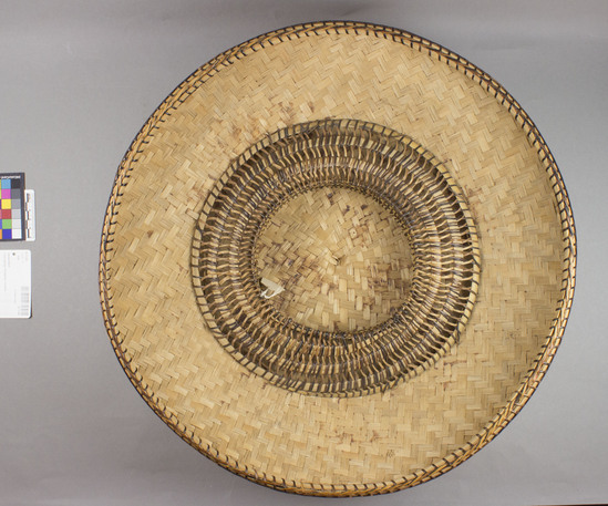 Hearst Museum object titled Hat, accession number 10-1145, described as Woven basketry hat; round; domed; 3 bands nito trim with diamond design; split bamboo twill lining; nito and bamboo coiled headring 17 3/4” dia. Same as 1143, see Kroeber, pg. 125.