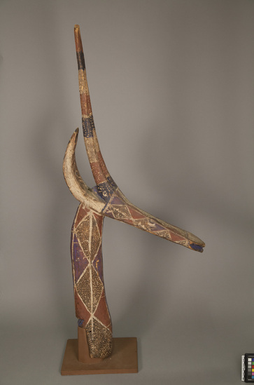 Hearst Museum object titled Mask/headpiece, accession number 5-13703, described as Headpiece; antelope head and neck, both elongated, ptd. wood with red ground, stippled diamonds in white on brown, some purple-blue markings; 4 carved horns; pegged into modern base;