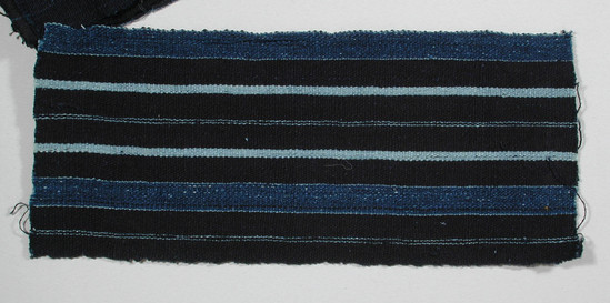 Hearst Museum object titled Textile fragment, accession number 5-11091, described as Textile sample (section of narrow band weaving): Navy ground with two stripes pale blue, eight lines pale blue.