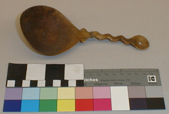 Hearst Museum object titled Spoon, accession number 1-1875, described as Handcarved of elk antler.  Round bowl with hole in bottom.  Zig zag handle with hole in tip.  Fiber binding near base of handle.