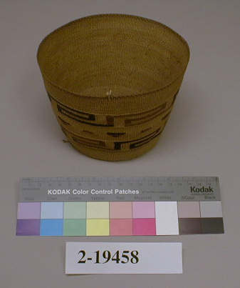 Hearst Museum object titled Basket, accession number 2-19458, described as Twined, wide mouth, flaring sides. Designs in dark purple, light brown, yellow and red. Cardboard stitched to bottom.