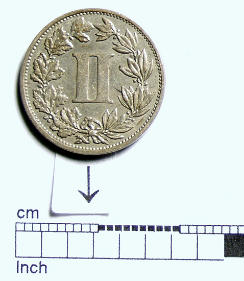 Hearst Museum object 6 of 6 titled Coin: 2 cent, accession number 3-23247, described as Nickle and copper alloy coin 2 centavos; 1.99 grams. Obverse: REPUBLICA MEXICANA 1882 Bow, quiver and mace in the center. Reverse: II surrounded by a wreath.