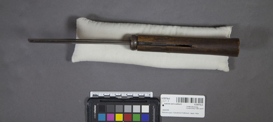 Hearst Museum object titled Hatchet and scabbard, accession number 9-23075a,b, described as Japanese hatchet ("nata") and scabbard ("saya"). Materials include linden ("shina") and wild grapevine bark ("budo").