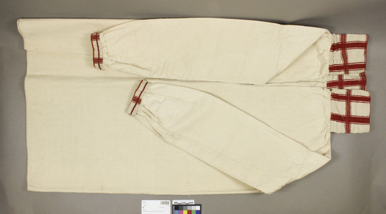 Hearst Museum object titled Camisa, accession number 3-114, described as Shirt (camisa); off-white plain weave; appears commercially manufactured; long sleeves gathered into cuffs; collar and cuffs of red and white plaid material; V-neck; approximately 81 cm long, 1 m 20 cm around hem