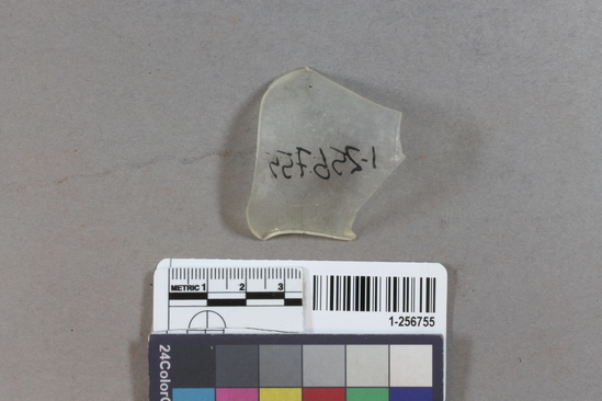 Hearst Museum object titled Glass fragment, accession number 1-256755, described as opaque glass, thin, curved side