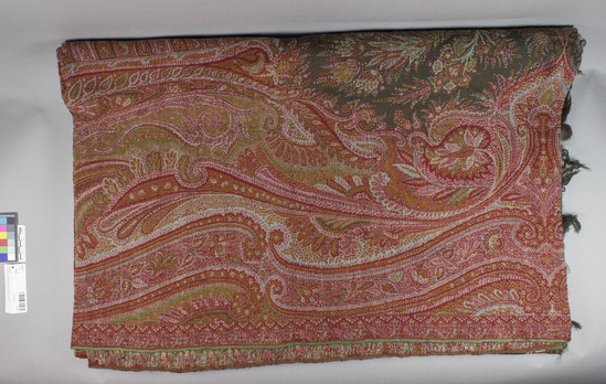 Hearst Museum object titled Shawl, accession number 7-6321, described as Paisley shawl; varicolored curvilinear and floral designs; black center; machine-woven wool; length is 3.06 meters, width is 1.62 meters not including fringe.