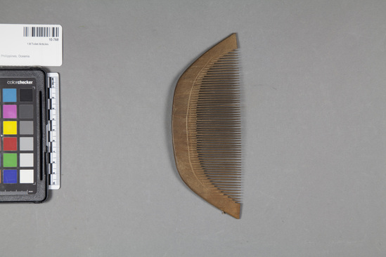 Hearst Museum object titled Comb, accession number 10-768, described as Wooden comb; curved back; incised line on each side.