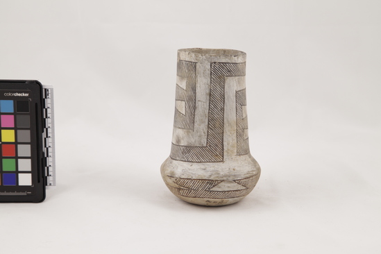 Hearst Museum object 2 of 4 titled Pottery, accession number 2-33565, described as Pottery pitcher; Chaco B/W; long neck; round body; handle missing; grey paste, classic meander on neck; inverted triangles on side. 6 1/8 inches high.