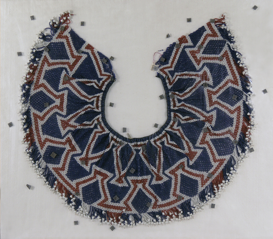 Hearst Museum object 2 of 2 titled Collar or cape, accession number 1-13867, described as Bead collar or cape; red, white, and blue.  Intricate geometric pattern of glass beads.  Bottom decorated with many single strands of tiny solid glass beads with large glass bead at end.