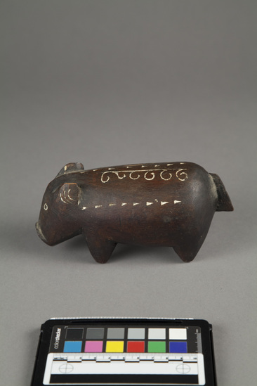 Hearst Museum object 1 of 3 titled Carving of pig, wood, incised, accession number 11-42725, described as Carving of pig, wood, incised; black with white incisions. length - 17.0 cm., height - 8.0 cm.