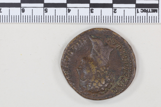 Hearst Museum object 9 of 14 titled Coin: æ sestertius, accession number 8-4887, described as Coin; AE; Sestertius; Roman. 22.80 grams, 32 mm. Marcus Aurelius, 148-149 AD. Rome, Italy. Obverse: AVRELIVS CAESAR AVG PII F, bust r. bare. Revere: TR POT III COS II, Pietas standing l., hand on head of small girl l.; in field, S C; in exergue, PIETAS. Remarks: Date is unlikely, falls during reign of Antoninus Pius.