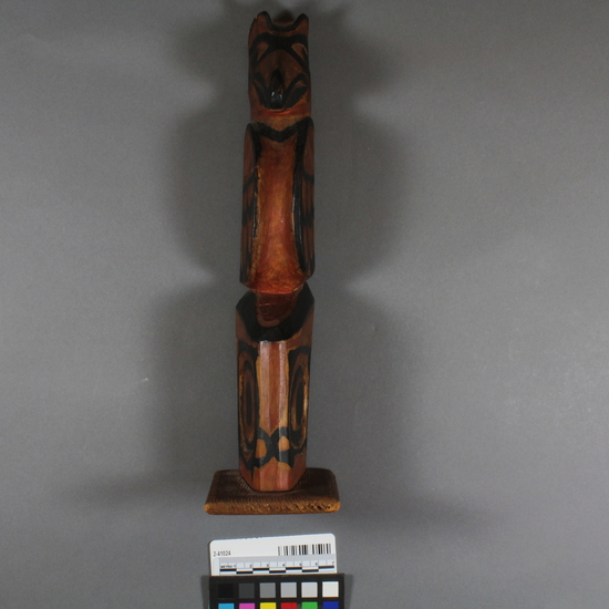 Hearst Museum object 2 of 4 titled Totem pole model, accession number 2-41024, described as Wooden totem pole model, carved and painted, on wooden base; upper half, which probably represents a raven, has carved head, black-painted details. Old label says "Kitkatlah, B.C.".