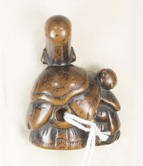 Hearst Museum object 5 of 12 titled Netsuke, accession number 9-18836, described as Netsuke; Fukurojoku and attendant; God with elongated head and small monkey (?) at his right side; smiling (?) face; possible seal in base; H 5.1 cm X W 3.5 cm