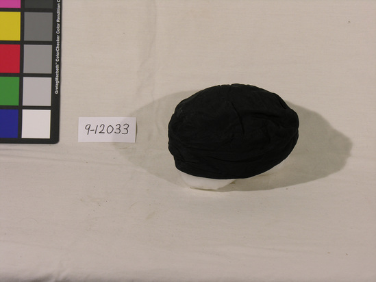 Hearst Museum object titled Cap, accession number 9-12033, described as Prayer cap; man’s; black taffeta, black cotton lining; worn while praying or visiting the temple by Parsi men.  While not as opulent as many other prayer caps, these taffeta caps have the virtue of being easily tucked away in a pocket for ready use.