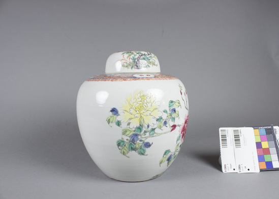 Hearst Museum object titled Jar with cover, accession number 9-12860a,b, described as ginger jar with cover; porcelain dec. w/ 5 color enamel; a) jar: peonies, rocks, cherry blossoms, butterflies, birds, leaves; phoenix on a rock; shoulder border design is wave pattern w/ 4 medallions each containing 2 red cherry blossoms; h. 17 cm., diam. ca. 17 cm.; b) cover: dec. with lotus and peach blossoms and a butterfly; rim diam. 9 cm.