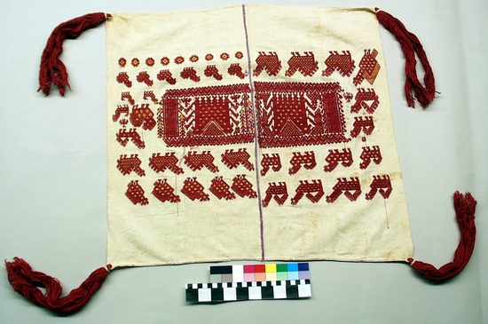 Hearst Museum object titled Tzute, accession number 3-41, described as Man’s headdress (xute); white cotton; plain weave; brocaded in red and yellow cotton; stitched together with violet silk thread; long red tassels on corners; approximately 65 cm x 60 cm; major motif chickens and corn in inlaid brocade, also two-headed bird; 2 pieces put together