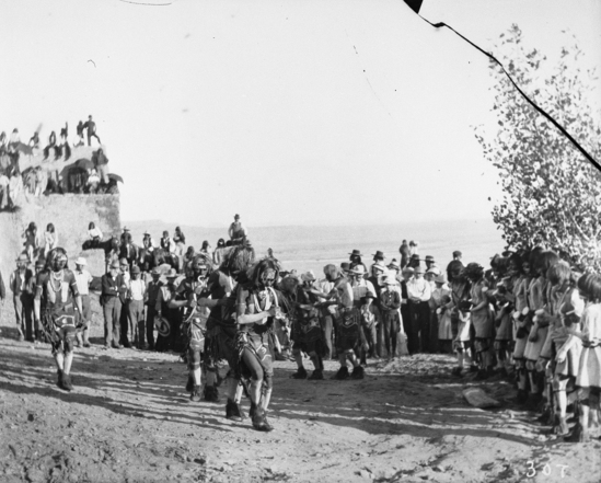 Hearst Museum object titled Black-and-white negative, accession number 15-307, described as Antelope priest chanting on right while Snake priests move out in a row holding snakes in their mouths.