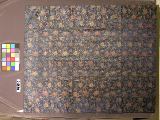 Hearst Museum object titled Robe, accession number 9-5660, described as Robe (mantle) worn by Buddhist priest; 13 patchwork strips within border; varicolored silk and gilt-paper strips brocaded on blue satin ground; floral design on swastika diaper background; blue silk lining; 112 x 198 cm