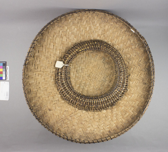 Hearst Museum object titled Hat, accession number 10-1143, described as Woven basketry hat; round; domed; 3 bands nito trim with diamond design; plain twill split bamboo lining; coiled nito and bamboo headring; 17 3/4” dia. Same as 10-1145. Broken on 1 side, 1963. See Kroeber, pg. 125.