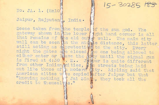 Hearst Museum object titled Black-and-white negative, accession number 15-30285, described as 4 X 5" Negatvive. Jaipur, Rajputana, India.  Image of sun god temple. Hoefler's original description: "Jaipur, Rajputana, India. Scene taken from the temple of the sun god. The gateway shown in the lower right hand corner is all that remains of the old outer wall. The main city wall can be seen in the middle distance, this latter still acting as a protection to the city. Every night the gates are closed, no one being allowed to either enter or leave the city until the signal gun is fired at 4:30 A.M. Jaipur is quite different from other Indian cities, its streets being laid out like those of a modern city. Kipling said that American cities were copied after Jaipur but that "knowing nothing of Jai Singh, they took all the credit to themselves." (Prints Supplied To: Mondiale, London; International News; General Tire Co.)